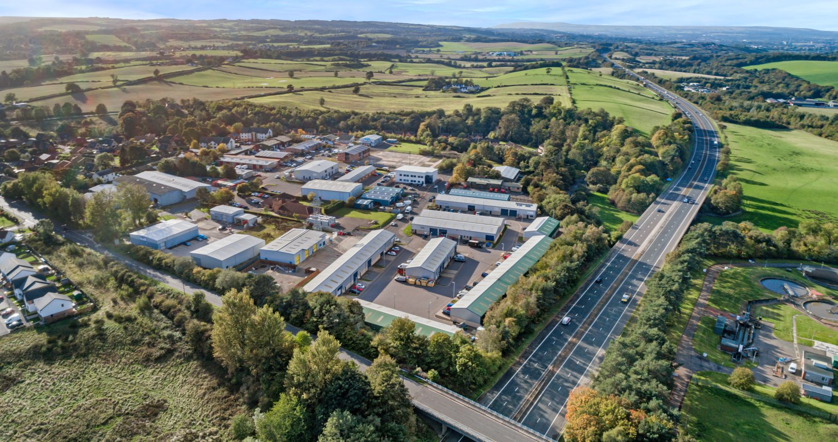 Aerial view of Mill Road Industrial Estate in Linlithgow, West Lothian, Scotland, showing industrial units and surrounding countryside.