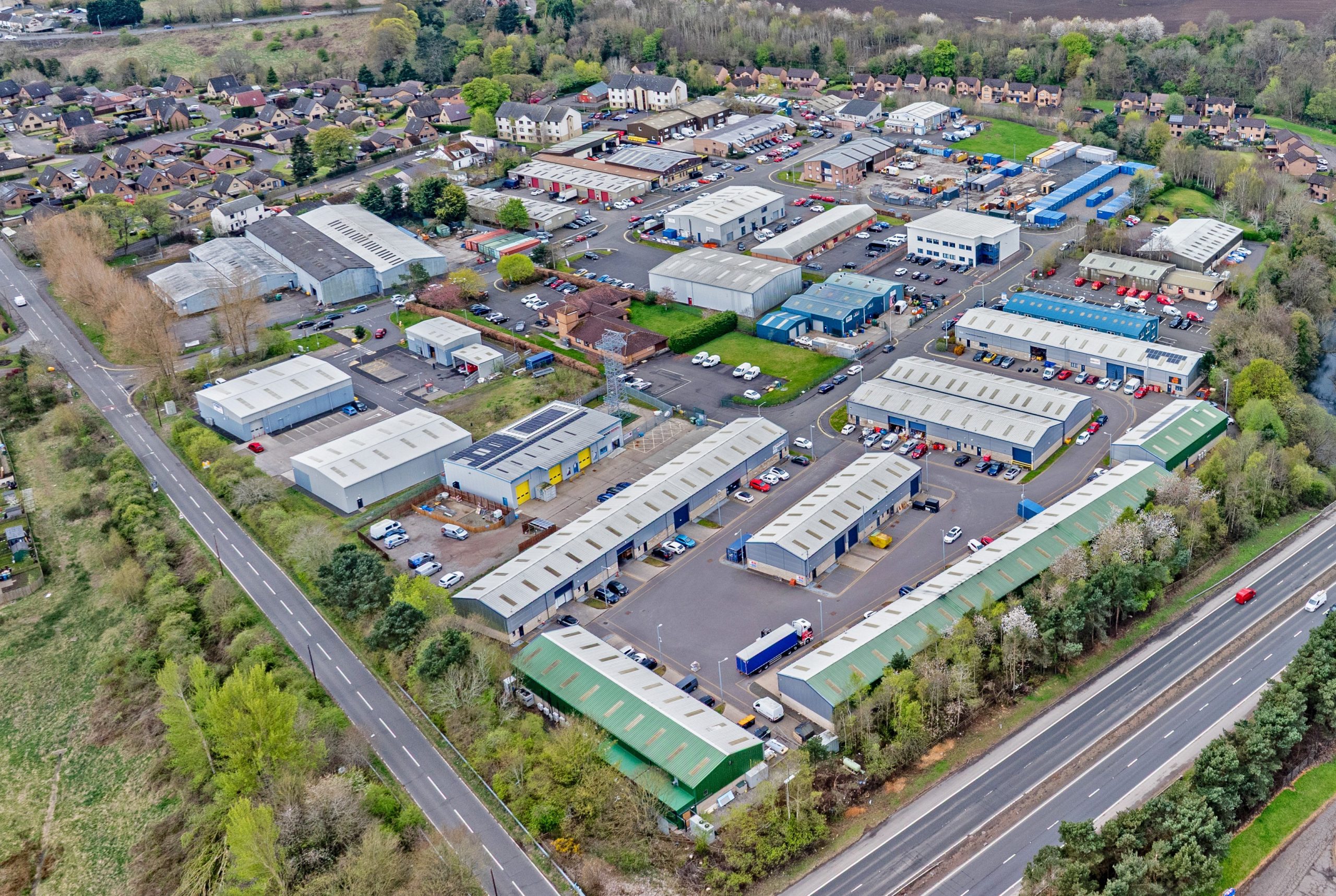 Aerial view of Mill Road Industrial Estate in Linlithgow, showing a variety of commercial units and tenant activity.