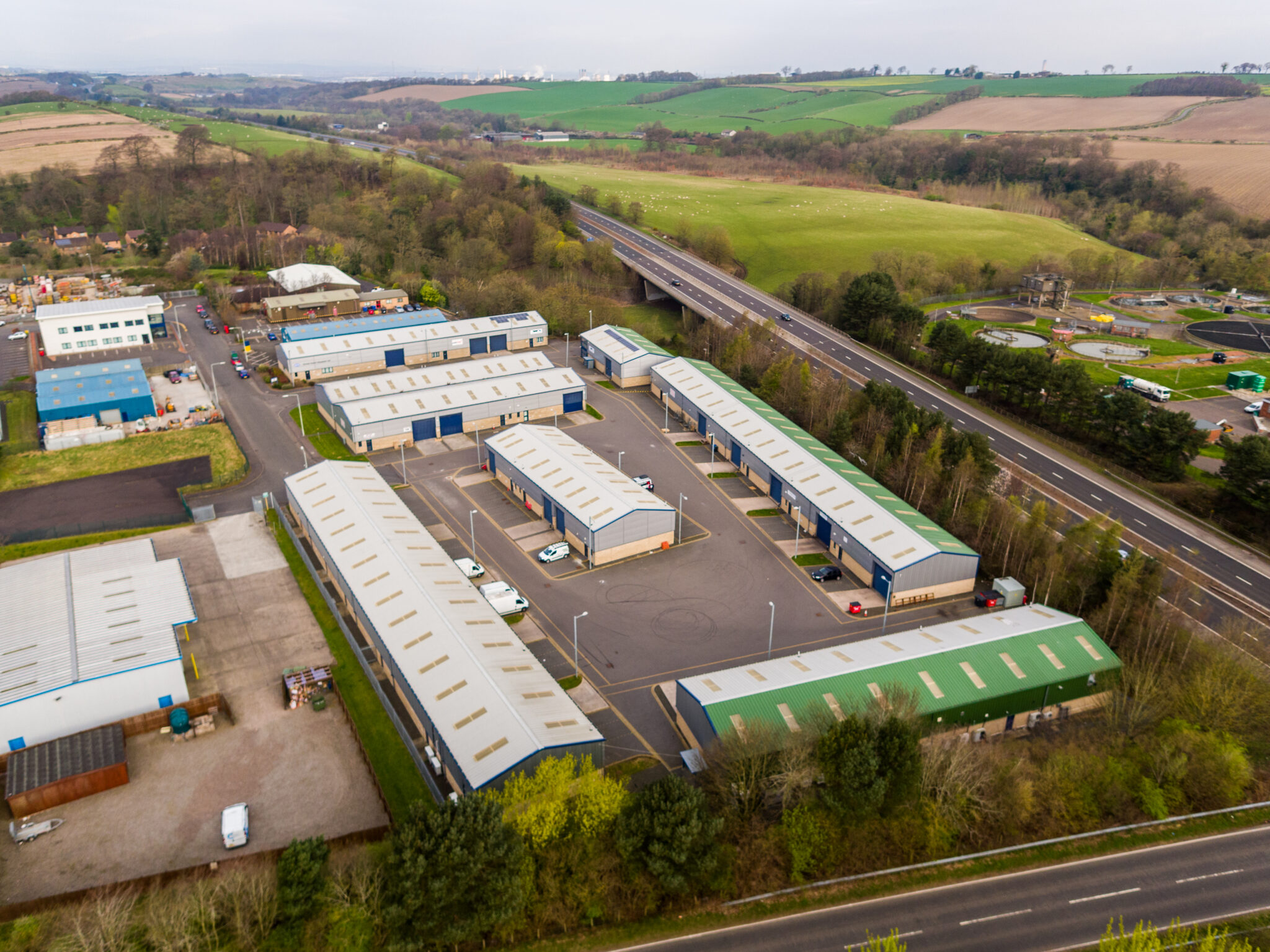 Aerial view of E-Net Park in Linlithgow, part of Mill Road Industrial Estate, showing modern light industrial units with excellent road access