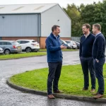 Business professionals talking outside a modern industrial unit, showing how commercial property first impressions are formed at Mill Road Industrial Estate in Linlithgow.