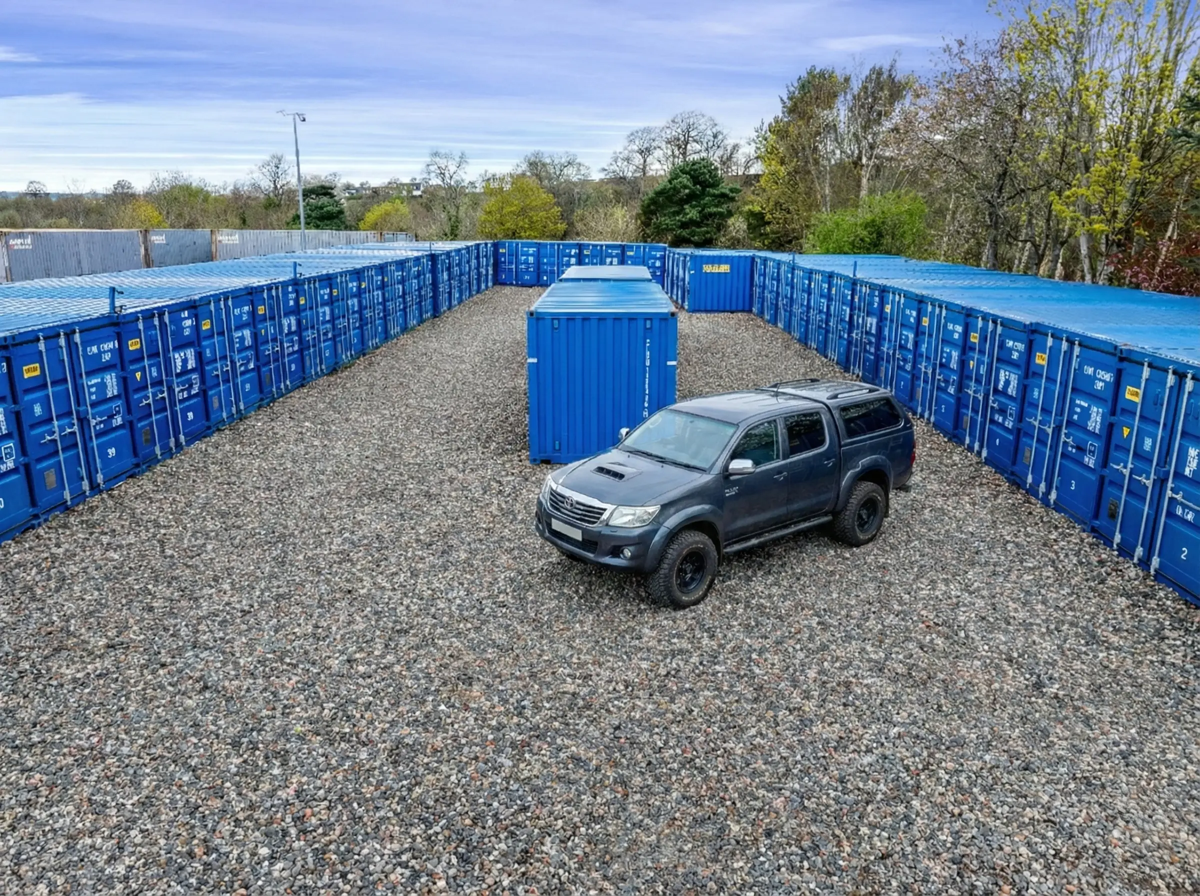 Drive-up-storage-for-businesses containers at Mill Road Industrial Estate in Linlithgow with direct vehicle access and secure outdoor layout